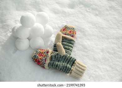 Knitted Mittens And Snowballs On Snow Outdoors