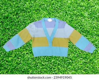 Knitted multicoloured stripe front button placket great background a beautifull  closeup view sweater and jumper. - Shutterstock ID 2394919045