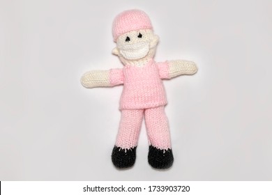 Knitted Nurse, Front Line Worker On White Background. Covid 19