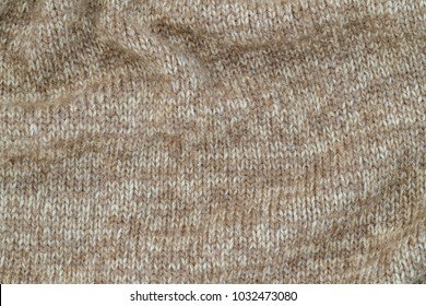 Knitted  Soft Cashmere Jumper Background, Close Up. Knitted Cloth  Texture Of Brown Beige Melange Blend Yarn. Fine-knit Pure Cashmere Jumper