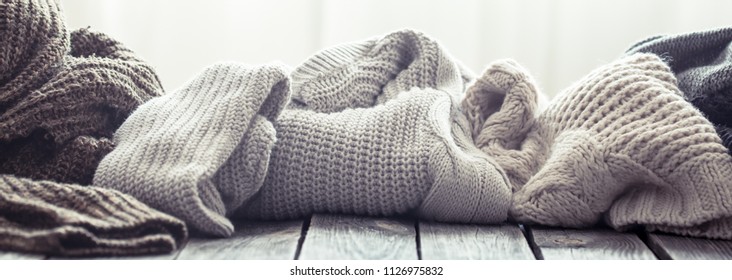 Knitted Sweater On A Wooden Background, Space For Text