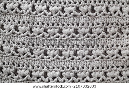 Knitted texture. Crocheted floral pattern.
