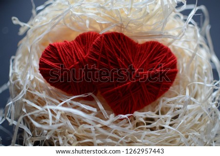 Knitted two eart on a raffia . Happy Valentine's Day.