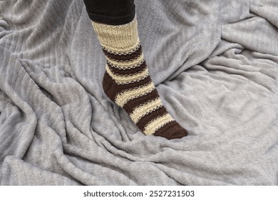 Knitted women's winter sock on the leg - education, magazines and marketing - Powered by Shutterstock