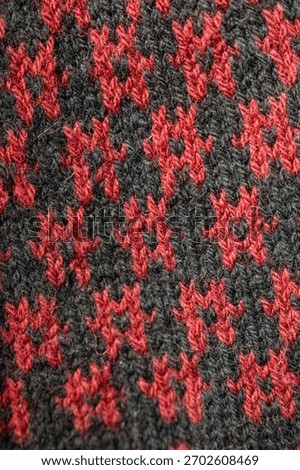Knitted Wool Fabric Pattern in Red and Dark Grey – Cozy Textile Close-Up