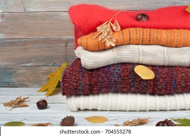 Knitted Wool Sweaters. Pile Of Knitted Winter, Autumn Clothes On Wooden Background, Sweaters, Knitwear, Leaf Space For Text