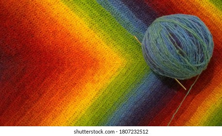 Knitted woolen fabric and yarn ball  Background from rainbow colours burgundy  red  orange  yellow  green  blue  violet  blueberry  Colorful knitting  Beauty geometry  Blurred color gradient 