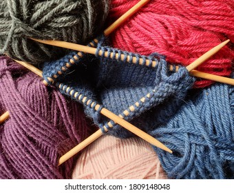 Knitting Club Concept - Balls Of Wool Yarn In Different Colors With Wooden Double Point Needles. Selective Focus.