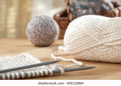 Knitting Needles And Yarn On Wooden Table, Still Life Photo With Soft Focus