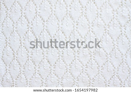 Knitting pattern, white rhombus design, lace fabric, handmade openwork knitted stitch mock up	