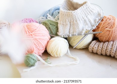Knitting project in progress. A piece of knitting with ball of yarn and a knitting needles.