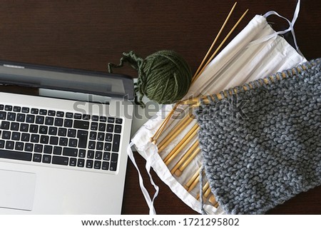 Knitting thread and needle case and laptot. Craft or knitting concept. Top view
