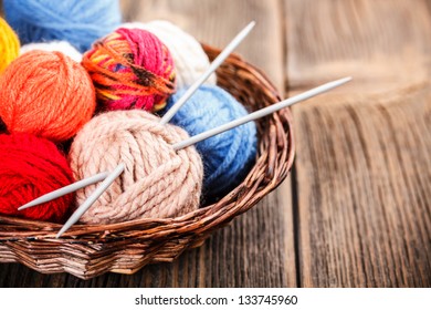 Knitting Yarn Balls And Needles In Basket