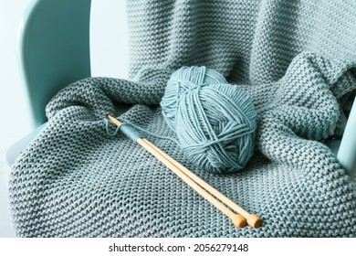 Knitting Yarn, Needles And Plaid On Chair, Closeup