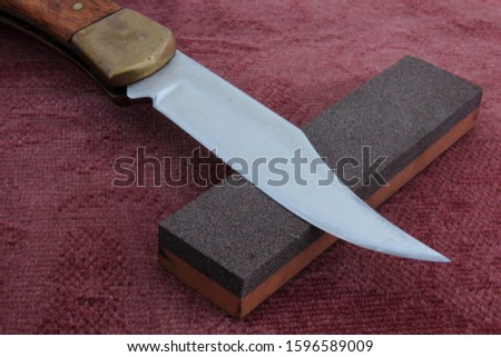 Knive sharpening stone with knife.