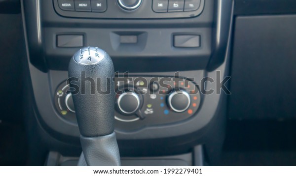 Knob for selecting the gear\
of a manual gearbox. Manual transmission knob in the car. Close-up\
of the gear shift lever. Vehicle interior. Detail of the\
car