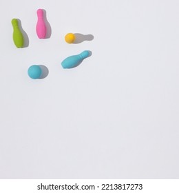 Knocked Down Bowling Pins On A White Background With Copy Space. Minimal Flat Lay Scene.