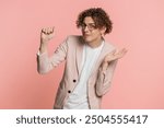 Knock-knock who is there. Confused excited Caucasian curly haired man in jacket knocking door gesture asking who is at home, feeling embarrassed no idea being clueless and uncertain on pink background