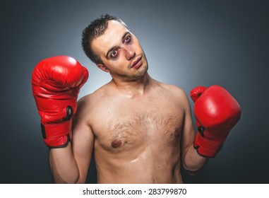 Knockout Kickboxer Over Dark Gray Background. Comic Weak Fighter With Red Sport Boxing Gloves. Waist Up Humor Kickboxer