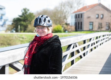 Knokke Heist, Flemish Region - Belgium - 04 03 2021: Portrait Of An Active Thirty Year Old Woman Posing At A Wooden Pier