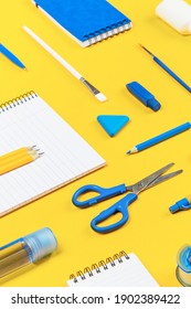 Knolling. Assorted Office Supplies And School White And Blue Stationery On Bright Yellow Background. Organized Knolling For Back To School Or Education And Craft Concept. Selective Focus