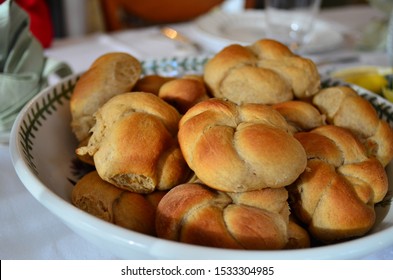 Knotted dinner rolls in a bowl at the Thanksgiving table - Powered by Shutterstock