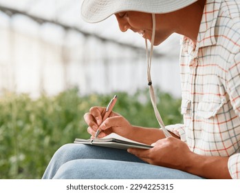 I know just what to plant next. Shot of a young man writing notes while working in a greenhouse on a farm. - Powered by Shutterstock