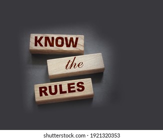 Know the rules word on wooden blocks isolated on dark grey background. business process regulation concept.