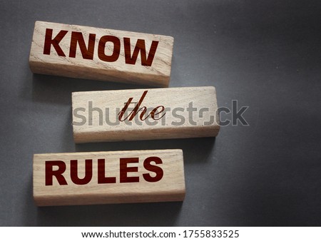 Know the rules word on wooden blocks isolated on dark grey background. business process regulation concept.