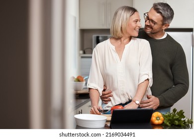 I Know That Whatever Youre Making Will Be Delicious. Shot Of A Mature Couple Cooking Together At Home.