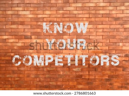 Know Your Competitors text on an old red brick wall background.