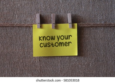 know your customer text on a yellow sticky note with three clips