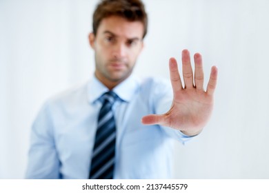 Know Your Limits. Portrait Of A Businessman With A Stern Expression And Holding Up His Hand In A Stop Motion.