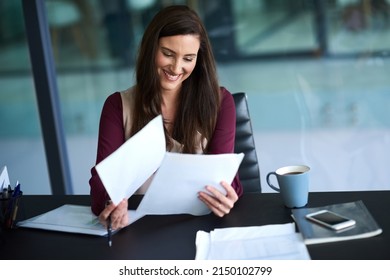 Knowing how to manage your workload is a valuable skill. Shot of a young businesswoman working on her admin.