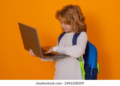 Knowledge day. School boy using laptop computer. Smart caucasian school boy kid pupil student going back to school. Education and knowledge