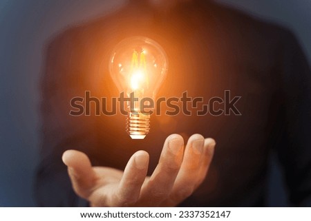 Knowledge idea bulb concept. Electric light bulb in hand business manager. Innovation, brain, creative concept