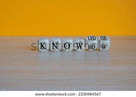 Knowledge and know-how symbol. Turned cubes, changes the word know-how to knowledge. Beautiful orange background, copy space. Business, knowledge and know-how