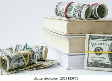 Knowledge leads to wealth. Stack of books with dollars. Concept of expensive education. Money in books. Saving money for college univercity. Savings, paid tuition