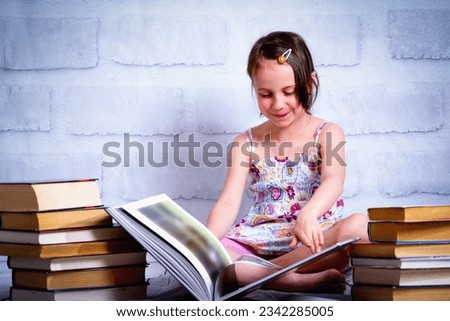 Knowledge and learning concept. Young cute child girl readin the book. 