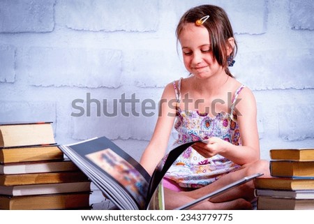 Knowledge and learning concept. Young cute child girl readin the book. Horizontal image.