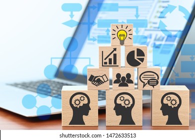 Knowledge Management And Business Intelligence Concept. Sharing Knowledge By Technology. Building Wood Blocks On Table. Laptop And Flowcharts.
