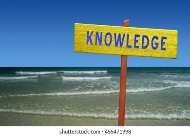 Knowledge sign on beach background