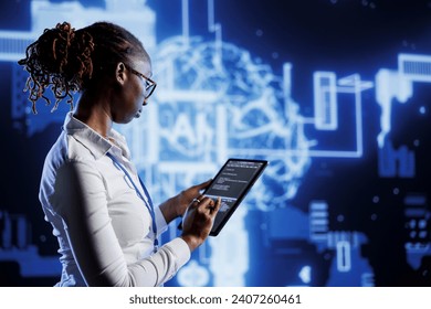 Knowledgeable admin updates neural networks made of interconnected nodes, writing intricate lines of code on tablet. High tech establishment employee uses programming to upgrade AI simulation model