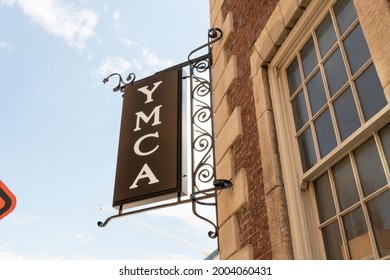 Knoxville, Tennessee - June 26, 2021: Exterior Wall Sign For YMCA Downtown With Metal Board Hanging From Brick And Mortar With Decorative Iron Bars