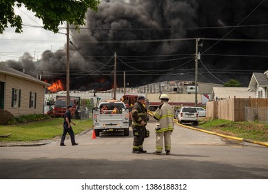 Knoxville, TN / United States -May 1, 2019: Firefighters And Police Coordinate To Fight A Fire At Fort Loudon Recycling And Waste Center In North Knoxville. 