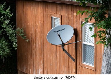 Knoxville, USA - June 2, 2019: Rustic Vintage Retro Wooden House Home Building With Windows In Countryside And HughesNet Satellite Dish In Tennessee