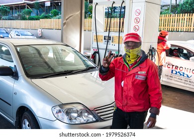 Knysna, South Africa, July 28th 2020 - Smiling And Masked African Petrol Attendant Poses Fr The Camera At A Petrol Station