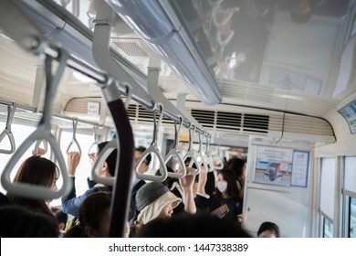 Kobe, Japan: October 11, 2018:  Passengers on a light rail train in Kobe, Japan.  Kobe has a population of 1.53 million people.   - Shutterstock ID 1447338389
