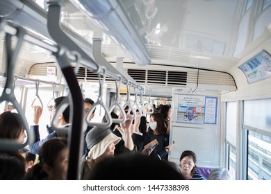Kobe, Japan: October 11, 2018:  Passengers on a light rail train in Kobe, Japan.  Kobe has a population of 1.53 million people.   - Shutterstock ID 1447338398
