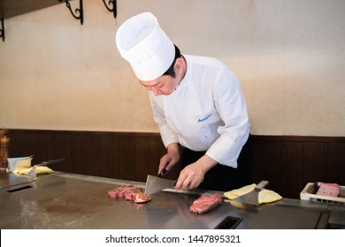 Kobe, Japan: October 11, 2018: A Japanese Chef Cooks Kobe Beef Steaks At A Steakhouse. Kobe Beef Is A Wagyu Beef Raised According To Strict Standards In Japan.